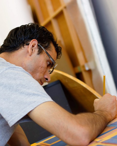 Ismael F. Alvarez painting in his studio